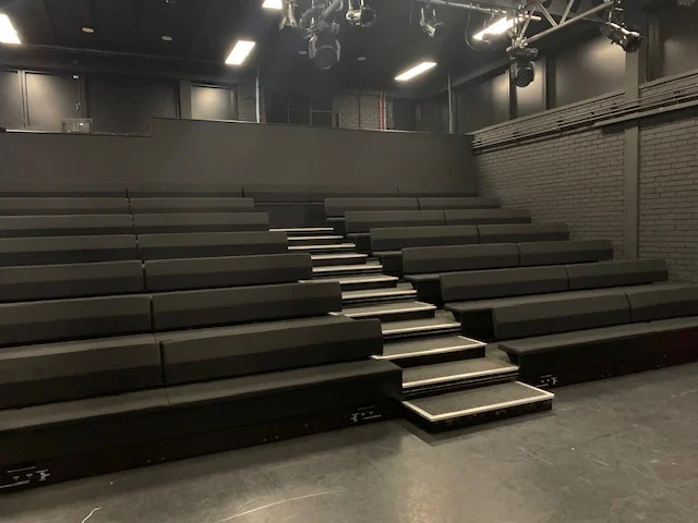Empty theater seating cleaned by Spotclean Ltd, offering office cleaning service.