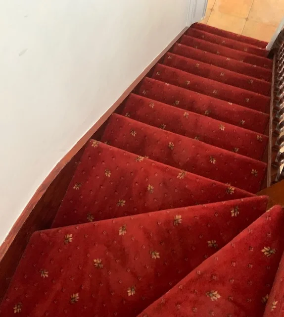 Red carpeted stairs freshly cleaned by Spotclean Ltd's Barking team.